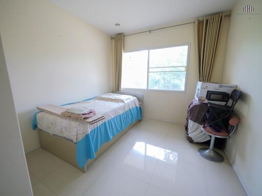 Simple bedroom with single bed and large window