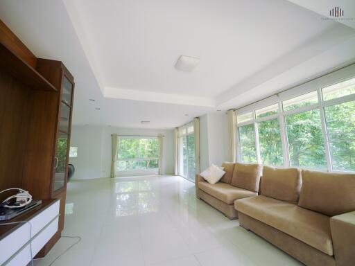 Spacious living room with large windows and natural light