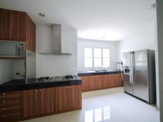 Modern kitchen with wooden cabinets and stainless steel appliances