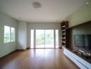 spacious living room with large windows and built-in shelves