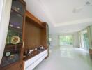 Spacious living room with large windows and built-in wooden cabinetry