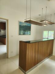 Kitchen area with island counter and wooden fixtures