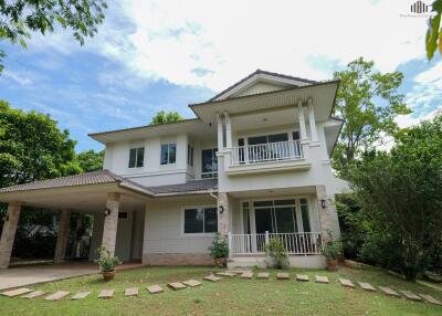 Exterior view of a two-story house with a well-maintained garden