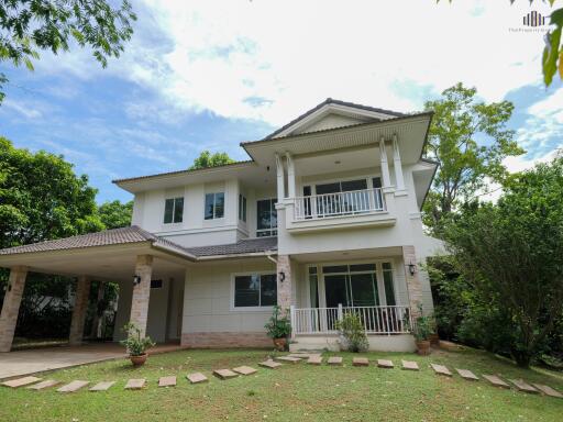 Exterior view of a two-story house with a well-maintained garden