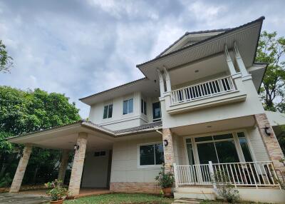 Exterior view of a two-story house with a front porch and balcony