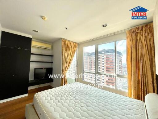 Modern bedroom with large windows and natural light