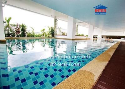 Modern indoor swimming pool with tiled floor