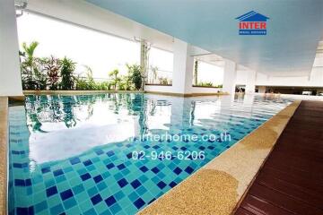 Modern indoor swimming pool with tiled floor