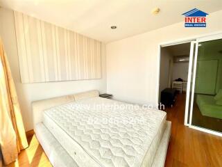 Bedroom with natural light and hardwood flooring