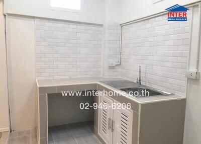 Modern kitchen with white subway tile backsplash and compact sink area