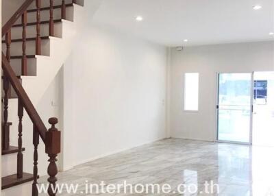 Spacious living room with a staircase and ample natural light