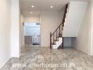 modern tiled living room with stairs leading to upper floor