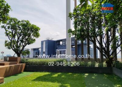 Outdoor building view with greenery and contact information