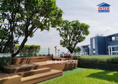 Modern outdoor seating area with trees and greenery