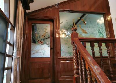 Intricately designed hallway with wooden panelling and glass art
