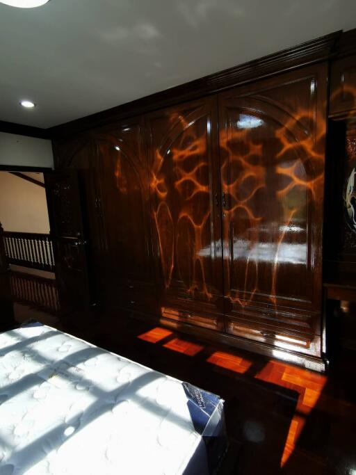 Bedroom with large wooden wardrobe and bed