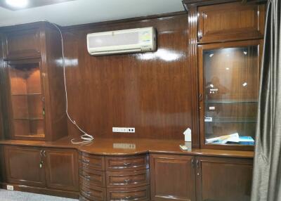 Living room with wooden cabinetry and air conditioning