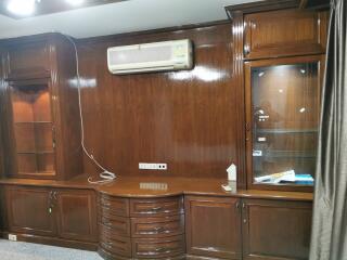 Living room with wooden cabinetry and air conditioning