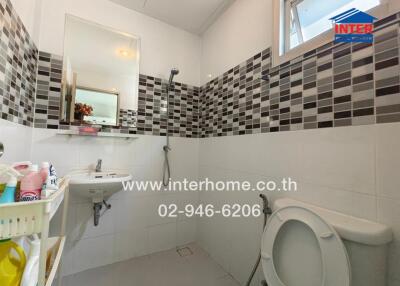 Modern bathroom with tiled walls and window