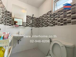 Modern bathroom with tiled walls and window