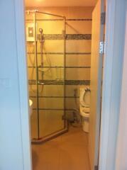 Bathroom with glass-enclosed shower and toilet