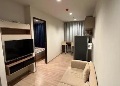 Modern living area with a view into the bedroom