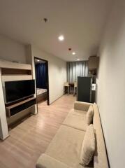 Modern living area with a view into the bedroom