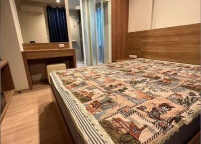 Well-lit bedroom with a double bed, wooden floor, and a large mirror wardrobe