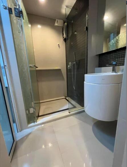 Modern bathroom with glass shower and floating sink