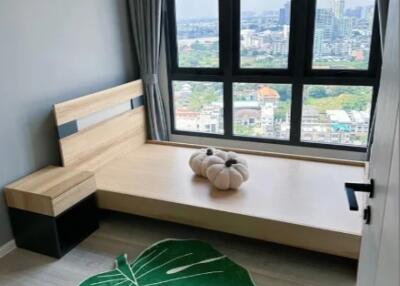 Modern bedroom with city view through large windows