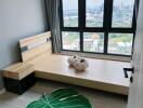 Modern bedroom with city view through large windows