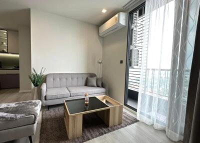 Modern living room with a sofa, coffee table, and air conditioning unit