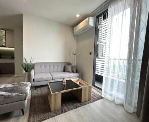 Modern living room with a sofa, coffee table, and air conditioning unit