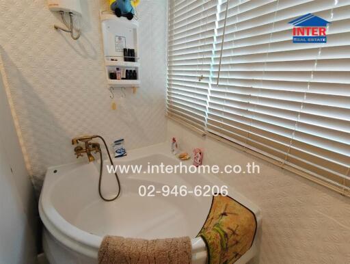 Bathroom with bathtub, blinds, and toiletries