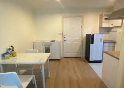 Small kitchen area with white furniture and appliances