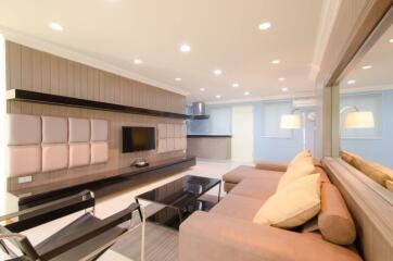 Modern and bright living room with wall-mounted TV and spacious seating area