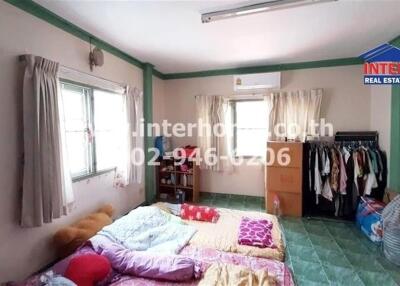 Bedroom with large window, air conditioner, and floor mattress