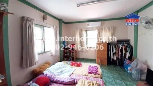 Bedroom with large window, air conditioner, and floor mattress