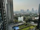 High-rise building with view of cityscape and swimming pool