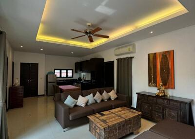 Modern living room with recessed lighting and comfortable furniture