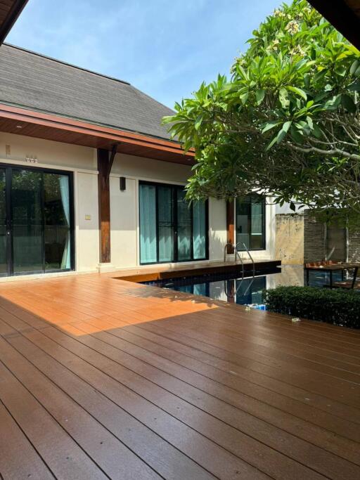 Beautiful outdoor deck with pool and lush greenery