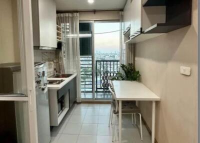 Modern kitchen with a small dining table and balcony view