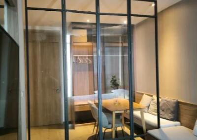 Bedroom with glass partition and view of dining area