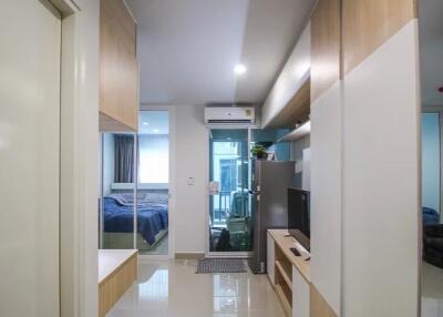 Modern living area with adjacent bedroom and kitchenette