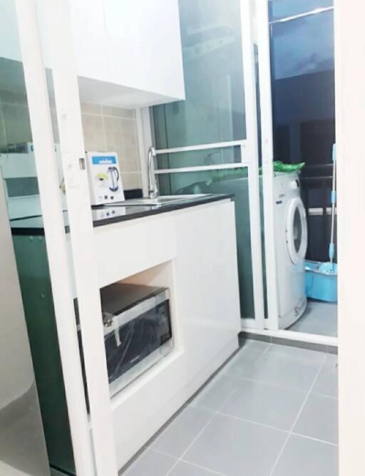 Modern compact kitchen with appliances and washing machine