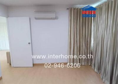Spacious bedroom with curtains and air conditioner