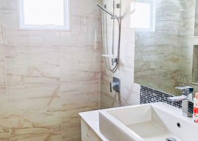 Modern bathroom with tiled walls and a sink