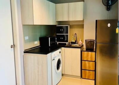 Modern kitchen with built-in appliances and washing machine