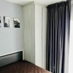 Bedroom with a wardrobe and dark curtains