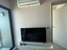 Small living room with a TV and air conditioner